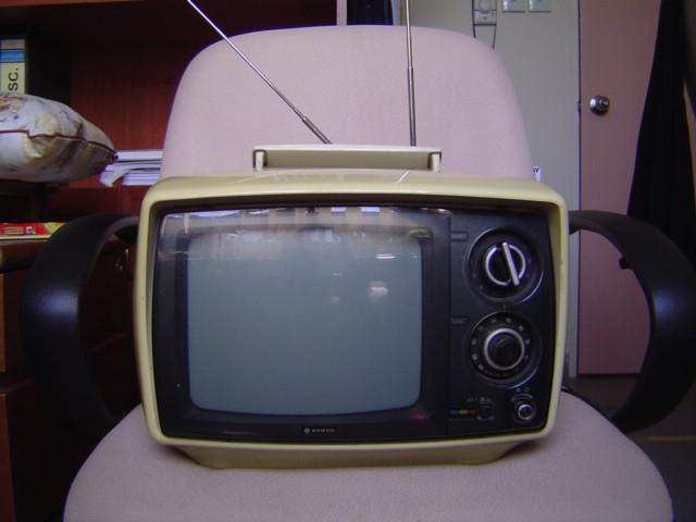 image of early portable television on chair