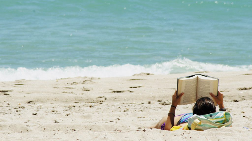 Woman reading on a beach.