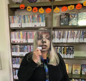 Staff holding "Carrie" videotape in front of face