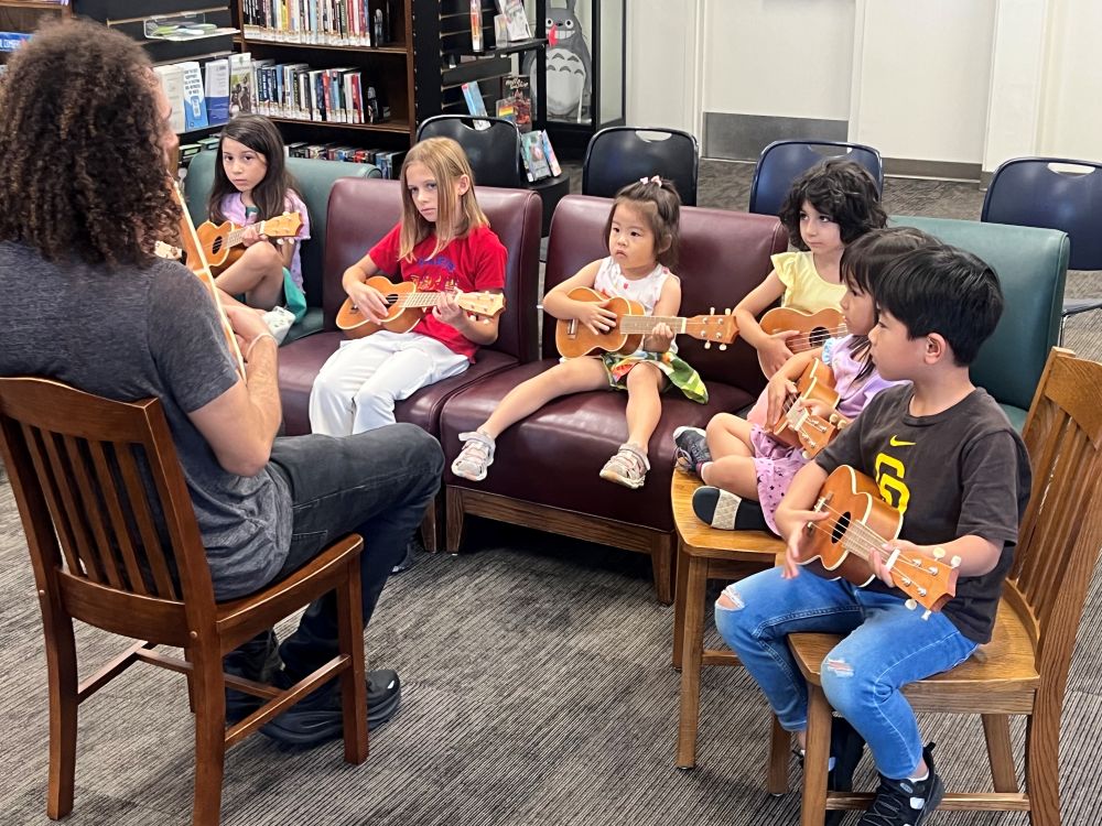 Kids holding ukuleles