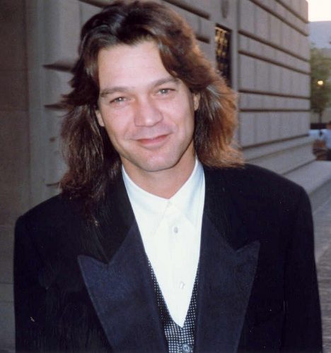 Color image of Eddie Van Halen in shirt and jacket, with long hair. Image dates from 1993 by Alan Light, used under CC by 2.0 license from wikimedia.