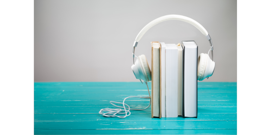image of blue wooden table top with three books inside headphones